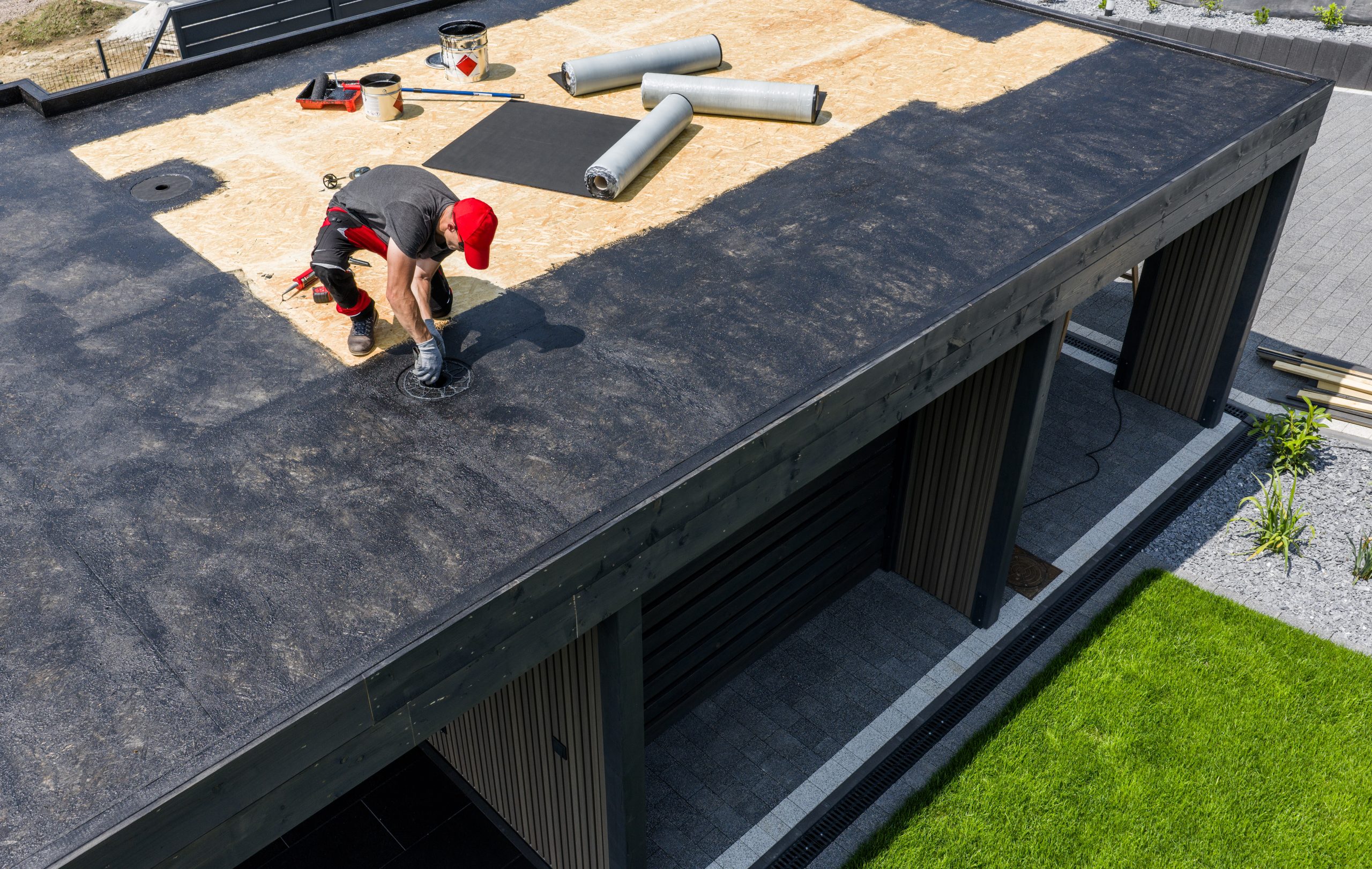 Roofer installing a new flat roof Roofer installing a new flat roof